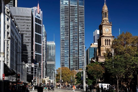 Modern skyscrapers next to historic City Hall under clear blue skies, Sydney, New South Wales,
