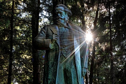 Marx monument in the sunlit forest of Grutas Park in Druskininkai, Druskininkai, Lithuania