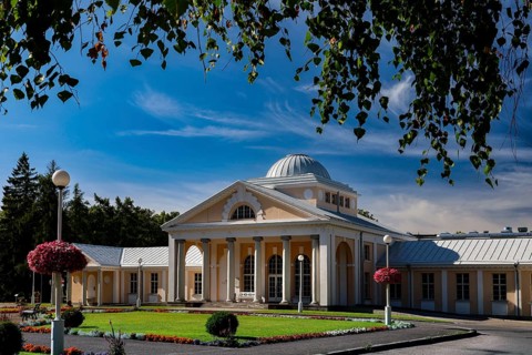 Elegant spa and hotel building in classical style with colonnades against a blue sky, Pärnu, Pärnu