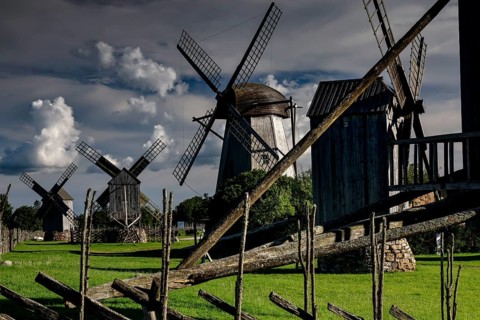 Traditional windmills in a green landscape with dramatic clouds, Angla, Saaremaa, Estonia