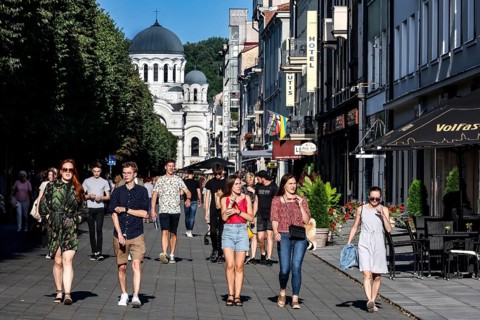 Laisves aleja in Kaunas with passers-by and the Church of Archangel Michael in the background,