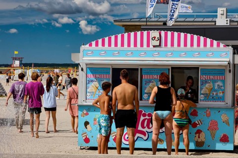 Ice cream stand on the beach promenade with numerous visitors in sunny weather, Pärnu, Pärnu