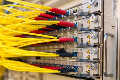 Yellow cables are plugged into a technical connection panel, Fiberglass-ground-breaking ceremony,