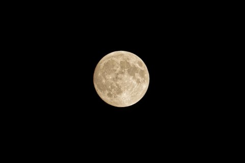 Full moon in the night sky, no clouds, black background. Poznan, Poland