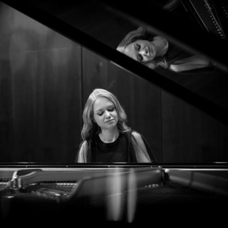 Young woman, pianist playing on a Steinway & Sons grand piano, black and white recording,