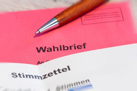 Absentee voting symbol: Close-up of a ballot letter with a ballot paper attached