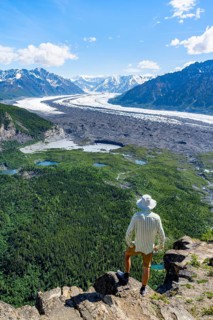 Young man enjoying the view, view of impressive mountain landscape with Matanuska glacier and