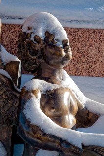 A snowy angel, figure at the Felix Mendessohn Bartholdy monument in winter with snow, Leipzig,