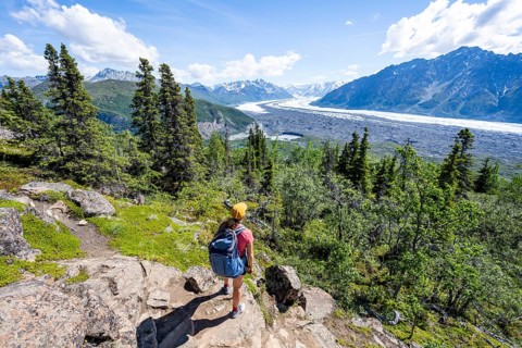Young woman enjoying the view, view of impressive mountain landscape with Matanuska glacier and