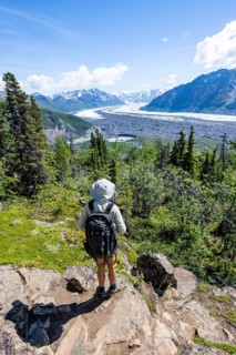 Young man enjoying the view, view of impressive mountain landscape with Matanuska glacier and