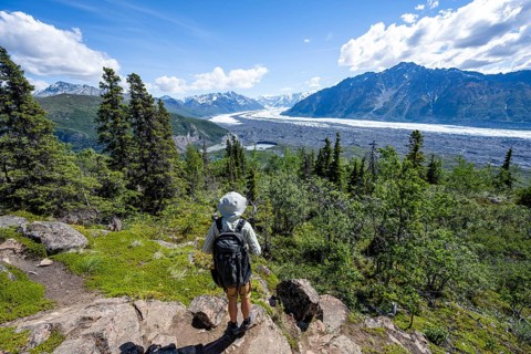 Young man enjoying the view, view of impressive mountain landscape with Matanuska glacier and