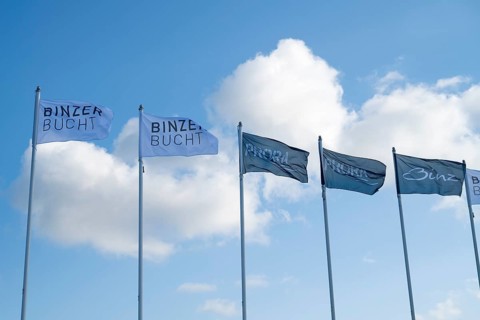 Flags against a blue sky with clouds, writing Binzer Bay and Prora, Binz, seaside resort, Rügen