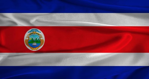 Flag of Costa Rica with fabric textured background. Close up of National flag of Costa Rica with