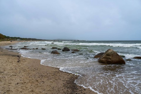 Boulders and waves on the coast, sandy beach, Baltic resort Göhren, Baltic Sea, Rügen island,