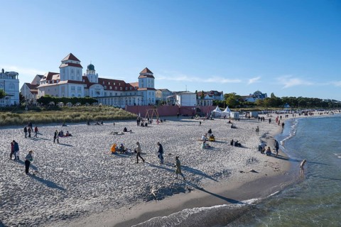 Tourists on the beach in autumn, spa hotel, Binz, seaside resort, Rügen island, Baltic Sea,