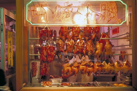 Ready to cook poultry in a shop window in Chinatown, New York City, USA