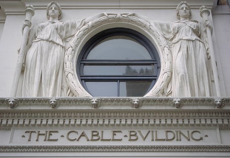 Two female sculptures above the entrance to the historic Cable Building, built in 1894 in Beaux