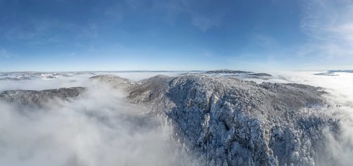 Aerial view of snowy stone walls and fog in the valley, Schwarzensee, Weissenbach an der Triesting,
