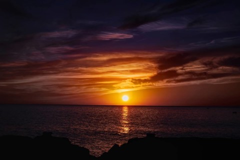 Impressive sunset over the sea with colorful skies and water reflections, Playa Blanca Lanzarote