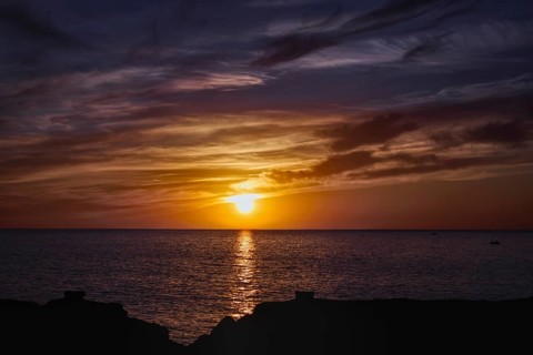Colourful sunset over the sea with reflective, dramatic cloud formations, Playa Blanca Lanzarote