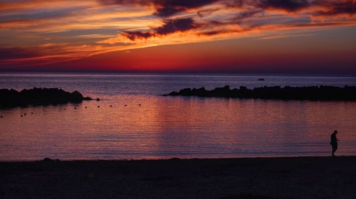 Twilight landscape with sunset, dramatic sky and silhouette of people on the beach (Playa Flamingo)