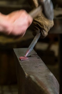 A blacksmith forging, working at the Ehnert forge in Dresden-Bühlau, Saxony, Germany