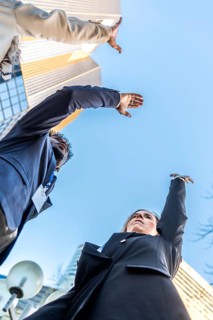 Diverse business professionals extending arms upwards, aiming for a shared objective and future