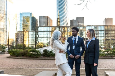 Diverse business professionals conducting an informal meeting and discussing ideas while standing