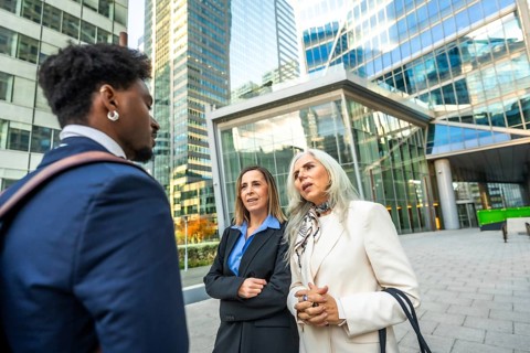 Diverse business professionals having an informal outdoor meeting, discussing ideas and