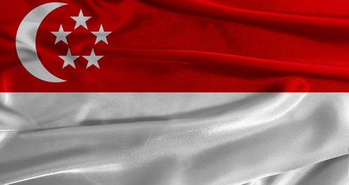 Flag of Singapore with fabric textured background. Close up of National flag of Singapore with