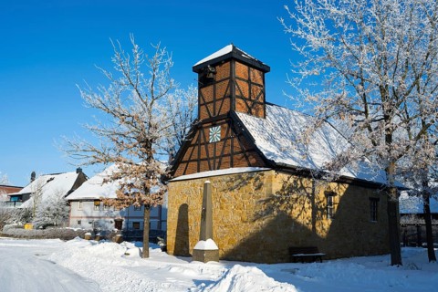 Snowy frame house in a village surrounded by snow-covered trees and clear sky, Old Chapel, 15th