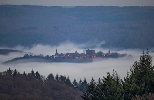 Aerial view of a medieval town, Dilsberg mountain fortress in a fog landscape in the Odenwald near