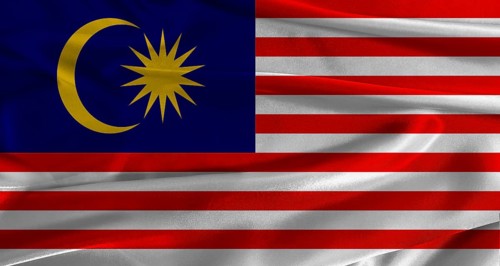 Flag of Malaysia with fabric textured background. Close up of National flag of Malaysia with