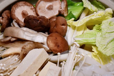 Japanese vegan nabe or nabemono soup dish with Chinese cabbage, tofu, enoki and shitake mushrooms