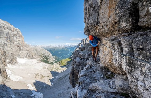 Mountaineers on a narrow band of rocks on the Via Ferrata Bocciere Centrale via ferrata,