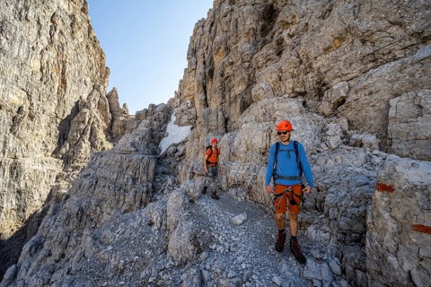 Two mountaineers on the Via Ferrata Bocciere Centrale via ferrata, spectacular mountain landscape