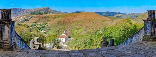 Historic churches and mountains of the city of Ouro Preto seen through stone columns, Ouro Preto,