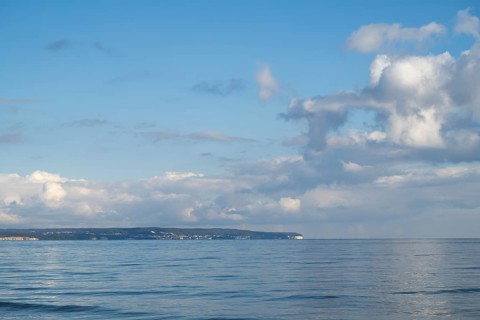 View across the Baltic Sea towards the chalk coast, sky with white clouds, Binz, seaside resort,