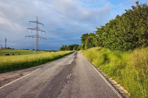 Landscape, road, high-voltage line, high-voltage mast, fields, trees, bushes, meadow, cloudy,