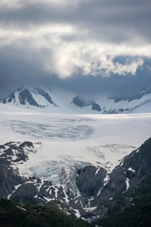 Mountain peak with Worthington Glacier glacier, dramatic cloudy sky, picturesque landscape on
