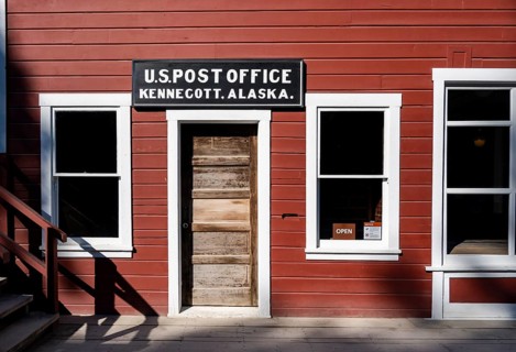 Red Kennicott buildings against mountainous landscape, Kennecott Post Office, Historic Kennecott