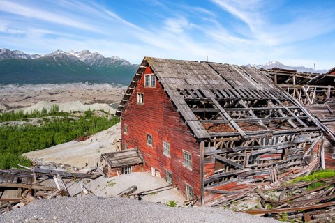 Red dilapidated buildings of Kennicott against mountainous landscape, Historic Kennecott Copper