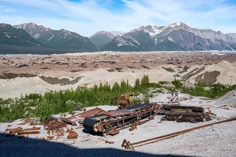 Old rusted metal scrap with conveyor belt, mountainous landscape and Kennicott Glacier, Historic