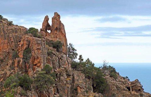 Heart shaped hole, bizarre rock erosions in the evening light, Calanche, Les Calanches de Piana,