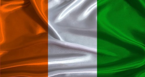 Ivory Coast flag with cloth textured background. National flag of Ivory Coast with realistic