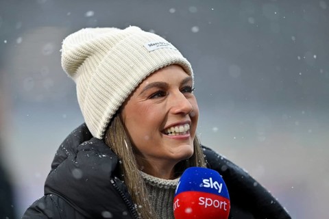 SKY reporter presenter Mara Mones wears hat in interview microphone micro logo portrait smiling,