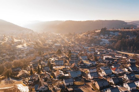 Overview of a village with wintry roofs and hills, Glatten, Freudenstadt district, Germany