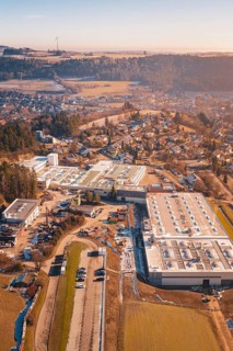Industrial plants next to a village in a hilly winter landscape, Glatten, Freudenstadt district,