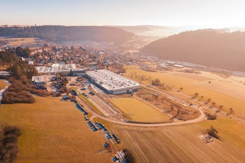 Factory next to a village in a hilly landscape on a winter morning, Glatten, Freudenstadt district,