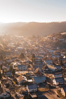 A village in a hilly landscape in the warm light of sunset, Glatten, Freudenstadt district, Germany